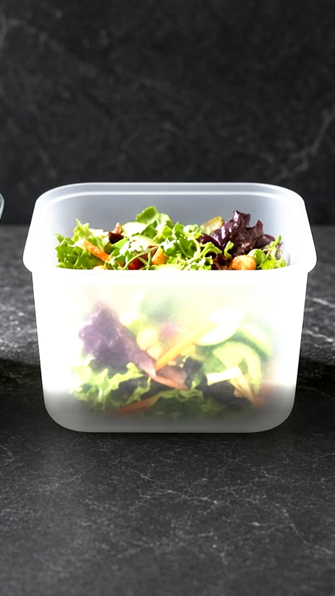 Glass, plastic, and stainless steel containers holding the same salad