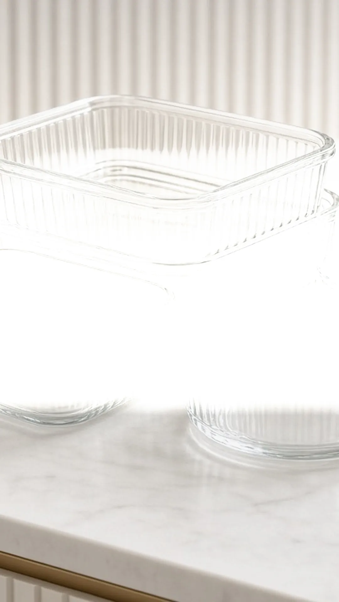 Stacked glass containers in rectangular, square, and round shapes